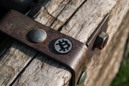 Made from black plastic custom bit coin on rustic old background