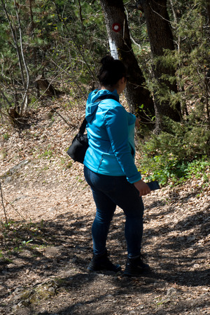 Girl walking in forest on mountain, dressed in blue clothesの写真素材