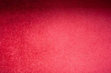 The texture of the red carpet carpet photographed up close with shadows on it.の写真素材