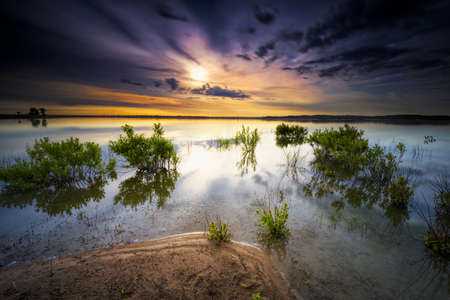 Texas sunrise over Benbrook Lake under a moody skyの写真素材