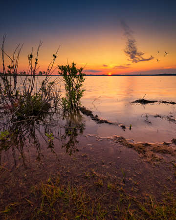 Vivid, multicolored sunrise over Benbrook Lake, Texasの写真素材