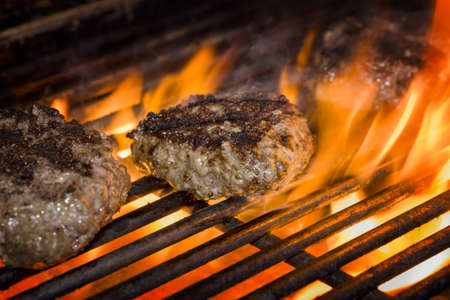 Premium beef burgers flame broiled on a gas grillの写真素材