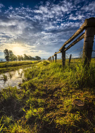 Misty sunrise reflecting off of a stream on Mormon Row in Grand Teton National Park, WYの写真素材