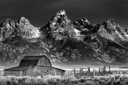 Iconic John Moulton homestead with the Wyoming Tetons serving as a dramatic backdropのeditorial素材