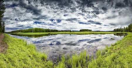 Swan Lake in Grand Teton National Park on a cloudy summer dayの写真素材