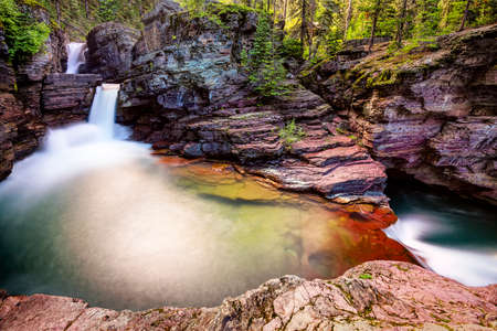 Red rocks and turquoise colored water at St  Maryの写真素材
