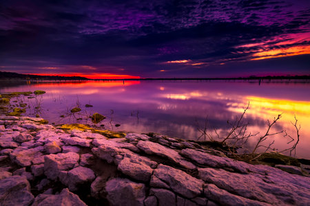 Colorful sunrise over  placid Benbrook Lake in North Texasの写真素材