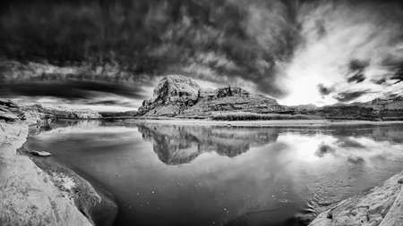Monochrome version of a spring sunset under ominous skies outside of Moab, Utahの写真素材