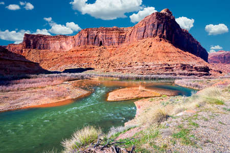 Late afternoon view of a colorful bend in the Colorado River outside Moab, UT