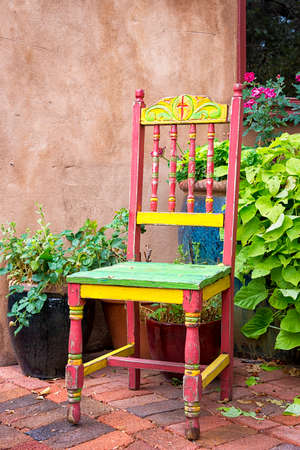Colorful old chair sitting outside on Canyon Road in Santa Fe, NMの写真素材