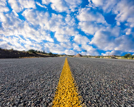 Street-level view of a desolate stretch of highway  in northern New Mexico