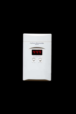 Wall plug-mounted carbon monoxide alarm with digital display isolated on a black backgroundの写真素材