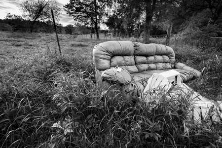 Abandoned sofa and chairs in a rural Texas fieldの写真素材