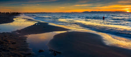 Colorful sunset over the Pacific Ocean at Wreck Beach in Vancouver, BCの写真素材