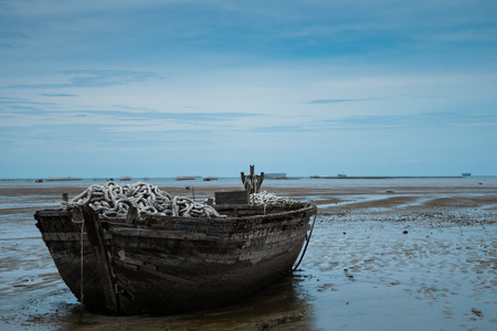 An old rowing boat in need of repair on the beach.の写真素材