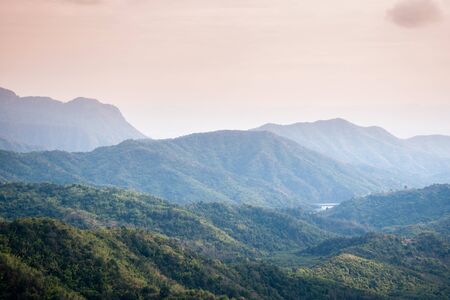 Sunrise landscape of foggy and cloudy mountain valley.の写真素材