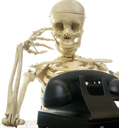 Skeleton waiting for the phone to ringの写真素材