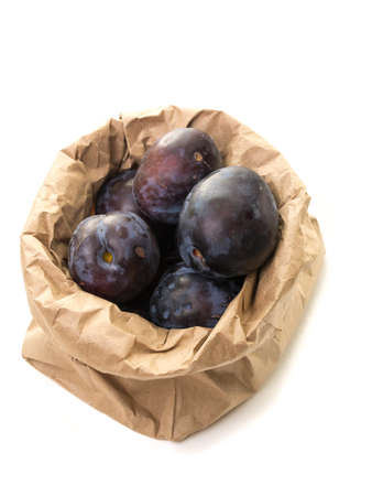 Fresh purple plums in a paper bagの写真素材