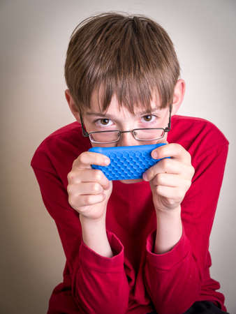 Teen boy texting on his cell phoneの写真素材