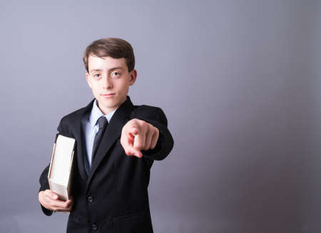 Young Attorney or businessman with large book pointingの写真素材