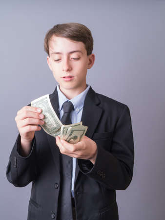 Young businessman or attorney counting his moneyの写真素材