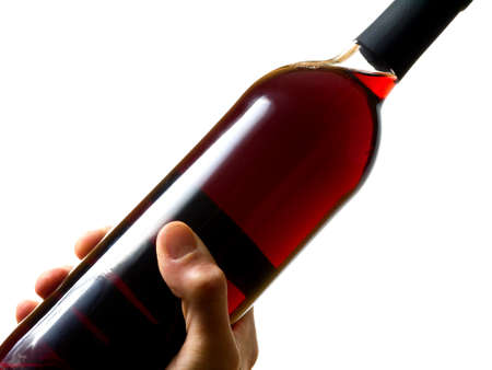 Hand holding a bottle of red wineの写真素材