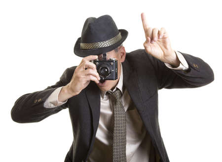 Man taking photograph with vintage cameraの写真素材