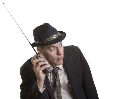 Man listening intently to portable radioの写真素材