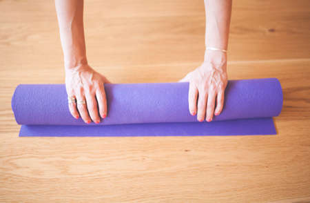 Yogi rolls the mat with his handsの写真素材