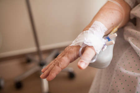 woman's hand with intravenous line in hospital roomの写真素材