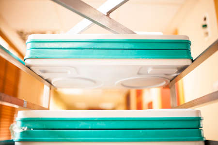 trays of food in cage in hospital corridorの写真素材