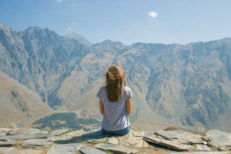 Hiker with backpack Hiking on the top of the mountain a Young Woman, a Girl. A Healthy Active Lifestyle. Adventure in nature.の写真素材