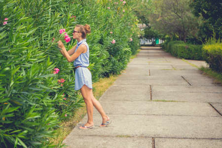 Portrait of a girl with flowers. Blue dress