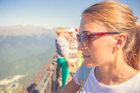 Happy woman traveler in the mountains and the landscape of mountains and blue sky Travel lifestyle concept of adventure summer holidays.の写真素材