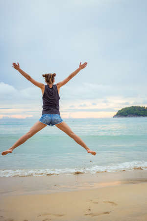 Young girl on blue sea background. Tropical country. Beach waves. Sunset. Dawn. Thailand Phuket Kataの写真素材