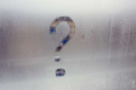 Autumn rain, the inscription on the sweaty glass - question markの写真素材