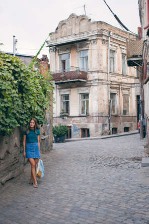 Beautiful young woman on the bridge of peace in Tbilisi, Georgia old town cityの写真素材