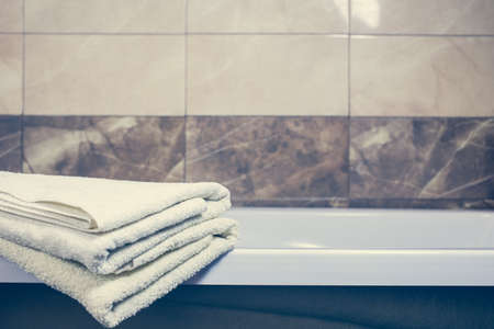 Blurred bathroom interior background and white spa towels on Marble Bathtub Mirror Faucetの写真素材