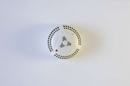 The wall of the smoke sensor on the ceiling of the circular..の写真素材