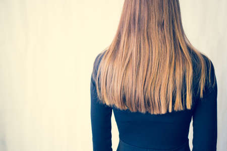 Beautiful woman in black dress, Studio isolated on white background. Golden hair.の写真素材