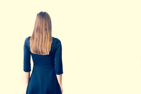 Beautiful woman in black dress, Studio isolated on white background. Golden hair.の写真素材