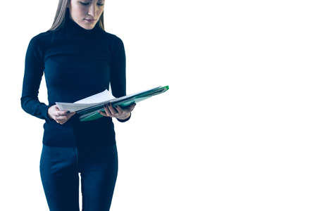 A girl with a folder of papers on white background. isolate.の写真素材