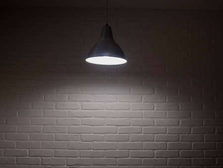 Rustic old studio with wooden table for product display or showcase and bright light shining from the top. Brick wall blurred background.の写真素材