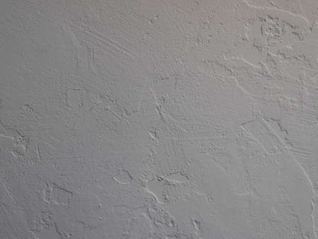 White abstract background or texture of concrete wall with rough stucco. Textured damaged plaster,...