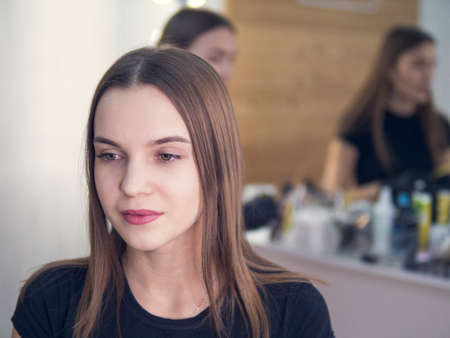 professional make-up in the beauty salon master makes a professional fresh summer make-up of a beautiful model in the salonの写真素材