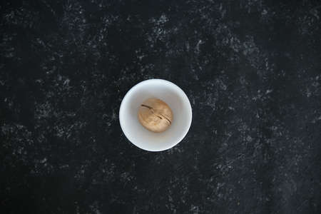 walnuts on a solid black background. Food background. Kitchen. a white plate. top viewの写真素材