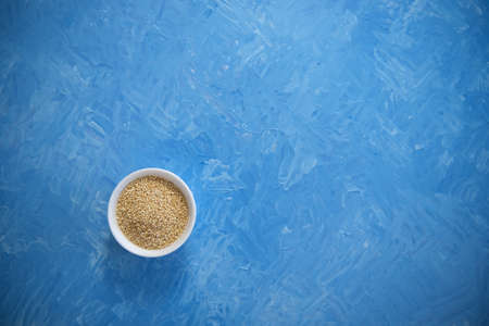 Quinoa is an organic food for healthy eating. In a round bowl. The blue background is painted with oil paintsの写真素材