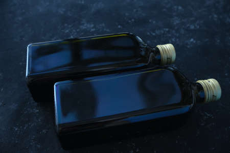 two black bottles on a dark background. Top view. Soft focus. Minimalism.の写真素材
