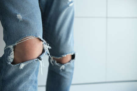 close-up of a man in torn jeans. Blue, old, fashionable, shabby. On a white background. Italian fashionの写真素材