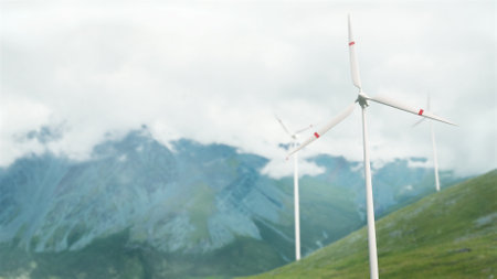 Wind turbines on a mountain pass, renewable energy. Clouds are floating, a hazy haze. snow. The...